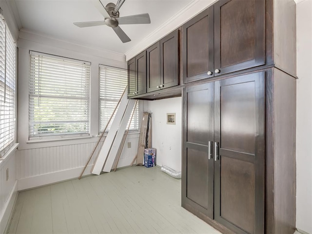 3216 NW 19th St, Oklahoma City, OK 73107 - interior space featuring cabinet space, hookup for a washing machine, a ceiling fan, crown molding, and light wood-style floors