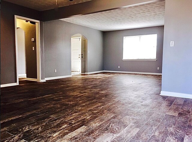 503 Kingston Dr, Yukon, OK 73099 - spare room featuring baseboards, wood finished floors, and arched walkways