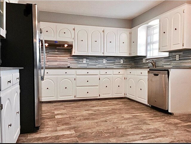 503 Kingston Dr, Yukon, OK 73099 - kitchen featuring stainless steel appliances, white cabinetry, dark countertops, and tasteful backsplash