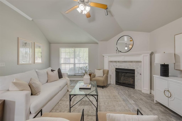 15924 Sky Run Dr, Edmond, OK 73013 - living area with light wood-type flooring, ceiling fan, vaulted ceiling, and a tile fireplace