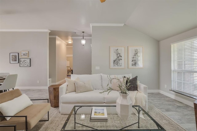 15924 Sky Run Dr, Edmond, OK 73013 - living area with crown molding, baseboards, wood finished floors, and lofted ceiling
