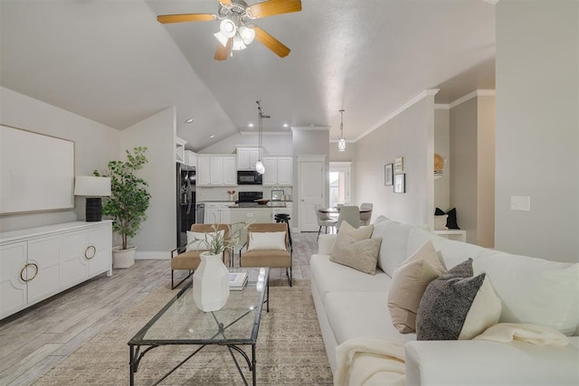 15924 Sky Run Dr, Edmond, OK 73013 - living room featuring ceiling fan, baseboards, light wood finished floors, lofted ceiling, and ornamental molding
