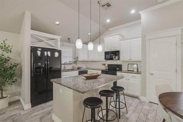 15924 Sky Run Dr, Edmond, OK 73013 - kitchen with a kitchen island, wood tiled floor, a sink, dark stone countertops, and black appliances