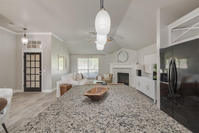 15924 Sky Run Dr, Edmond, OK 73013 - living room featuring a ceiling fan, visible vents, a fireplace, baseboards, and light wood-style floors