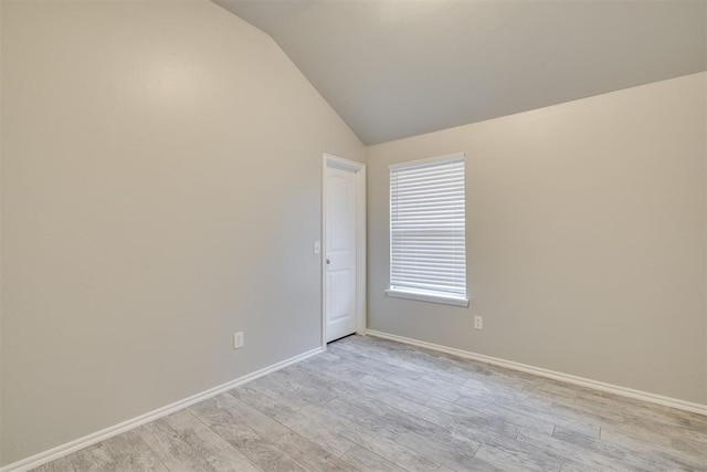 15924 Sky Run Dr, Edmond, OK 73013 - empty room with baseboards, lofted ceiling, and light wood-style floors