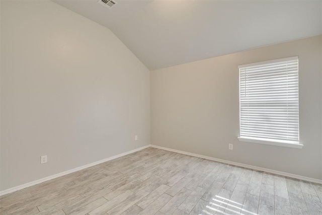 15924 Sky Run Dr, Edmond, OK 73013 - empty room featuring baseboards, vaulted ceiling, light wood-type flooring, and visible vents