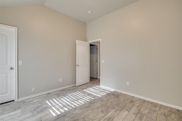 15924 Sky Run Dr, Edmond, OK 73013 - unfurnished room with baseboards, vaulted ceiling, and light wood finished floors