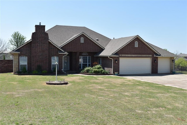 2297 Barrington Dr, Blanchard, OK 73010 - view of front of house featuring a chimney, a front lawn, driveway, an attached garage, and brick siding