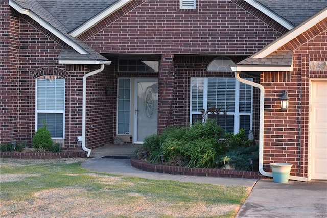 2297 Barrington Dr, Blanchard, OK 73010 - property entrance featuring a shingled roof, brick siding, and a garage