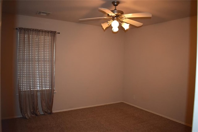 2297 Barrington Dr, Blanchard, OK 73010 - spare room with dark carpet, baseboards, a ceiling fan, and visible vents