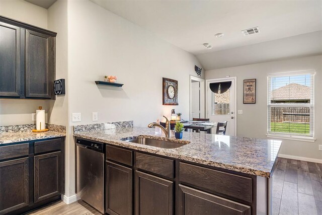 1105 NW 3rd St, Newcastle, OK 73065 - kitchen featuring a sink, a peninsula, visible vents, dishwasher, and light wood-style floors