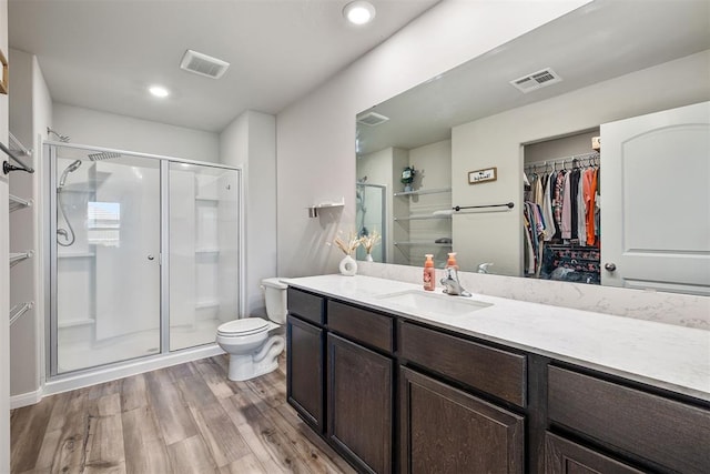 1105 NW 3rd St, Newcastle, OK 73065 - full bathroom with toilet, wood finished floors, a walk in closet, visible vents, and a shower stall