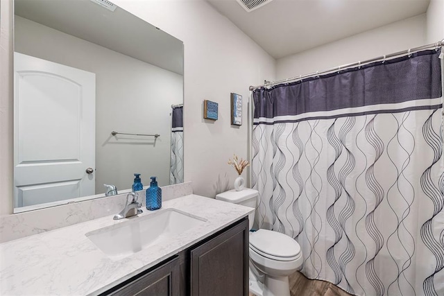 1105 NW 3rd St, Newcastle, OK 73065 - full bath with toilet, visible vents, a shower with shower curtain, vanity, and wood finished floors