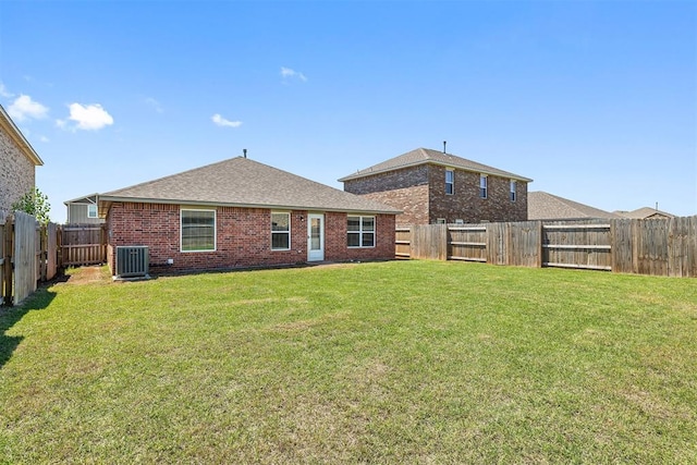 1105 NW 3rd St, Newcastle, OK 73065 - rear view of property featuring cooling unit, a lawn, a shingled roof, a fenced backyard, and brick siding