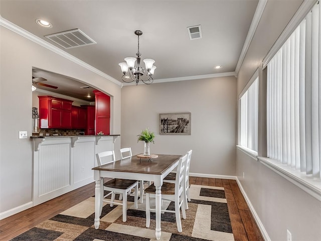 2105 SE 3rd St, Moore, OK 73160 - dining space featuring wood finished floors, visible vents, and crown molding