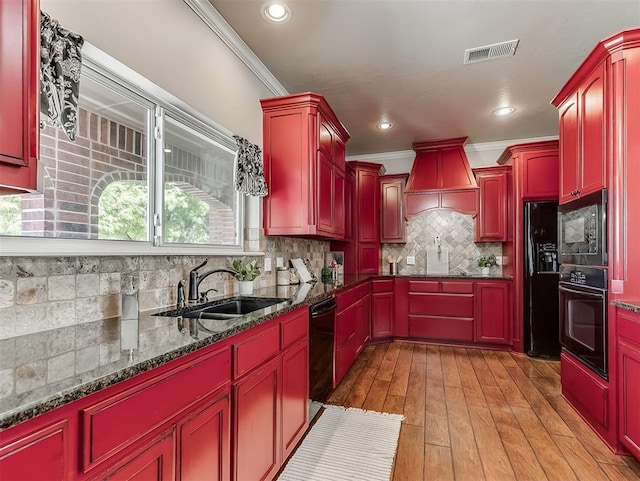 2105 SE 3rd St, Moore, OK 73160 - kitchen with dark brown cabinets, visible vents, a sink, crown molding, and black appliances
