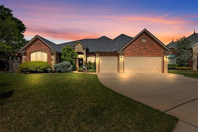 4608 Greystone Ct, Norman, OK 73072 - ranch-style home featuring a front lawn, driveway, stone siding, a garage, and brick siding