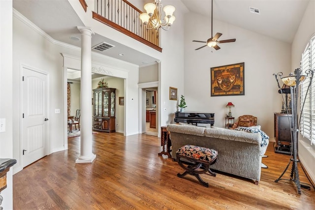 4608 Greystone Ct, Norman, OK 73072 - living room with wood finished floors, visible vents, ornate columns, and ceiling fan