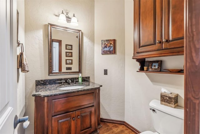 4608 Greystone Ct, Norman, OK 73072 - bathroom featuring a textured wall, wood finished floors, vanity, and toilet
