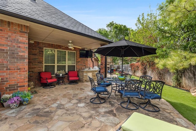 4608 Greystone Ct, Norman, OK 73072 - view of patio with a fenced backyard, a ceiling fan, exterior kitchen, and outdoor dining space