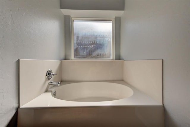 bathroom featuring a garden tub