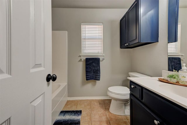 full bath with a tub to relax in, tile patterned floors, toilet, vanity, and baseboards