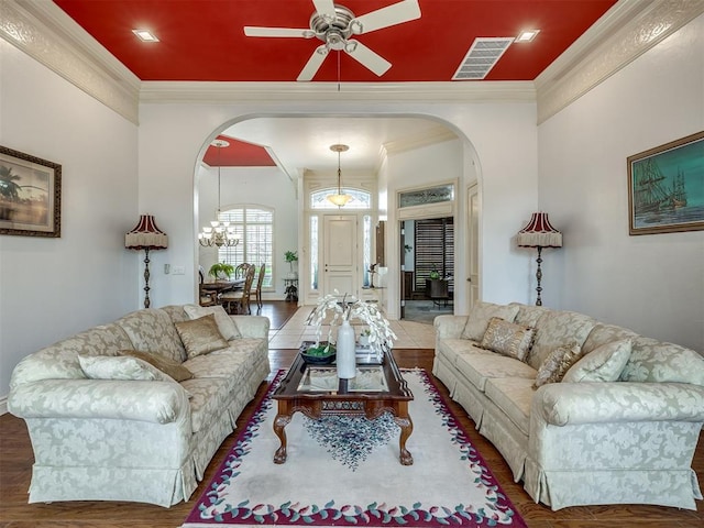 8016 NW 124th St, Oklahoma City, OK 73142 - living area featuring arched walkways, ornamental molding, a ceiling fan, a chandelier, and wood finished floors