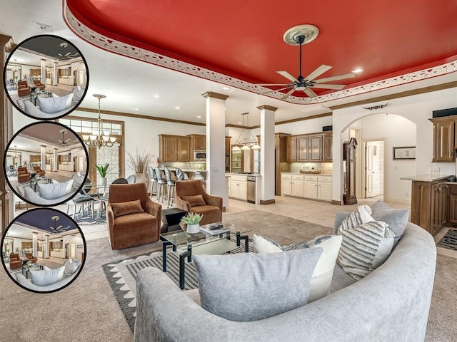 8016 NW 124th St, Oklahoma City, OK 73142 - living room with a tray ceiling, ceiling fan, ornate columns, light carpet, and arched walkways