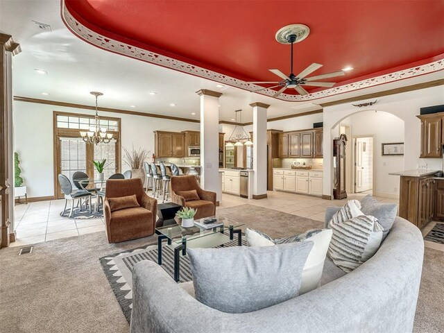 8016 NW 124th St, Oklahoma City, OK 73142 - living area with a raised ceiling, light tile patterned flooring, a ceiling fan, arched walkways, and light carpet