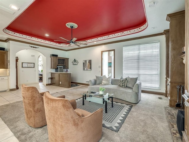 8016 NW 124th St, Oklahoma City, OK 73142 - living area featuring a raised ceiling, arched walkways, ceiling fan, healthy amount of natural light, and ornamental molding