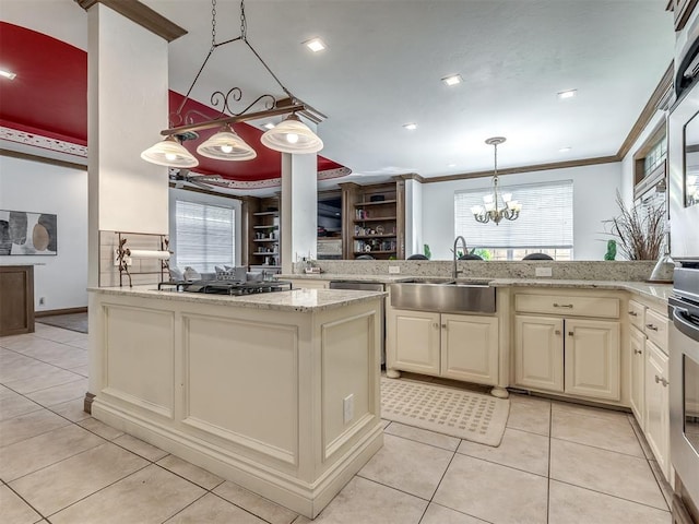 8016 NW 124th St, Oklahoma City, OK 73142 - kitchen with a sink, a peninsula, a chandelier, light tile patterned floors, and stainless steel gas cooktop