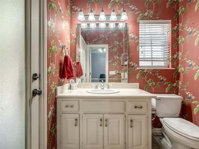 8016 NW 124th St, Oklahoma City, OK 73142 - bathroom featuring wallpapered walls, vanity, and toilet