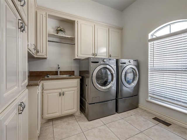 8016 NW 124th St, Oklahoma City, OK 73142 - washroom featuring cabinet space, separate washer and dryer, and light tile patterned floors
