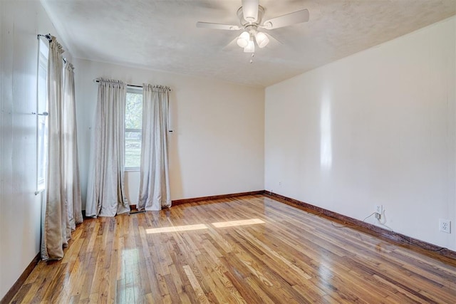 6205 S Choctaw Rd, Choctaw, OK 73020 - spare room featuring hardwood / wood-style flooring, baseboards, and a ceiling fan