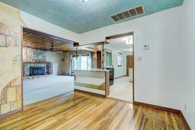 6205 S Choctaw Rd, Choctaw, OK 73020 - unfurnished living room with hardwood / wood-style flooring, baseboards, visible vents, and a fireplace