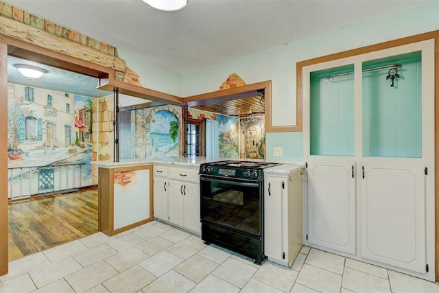 6205 S Choctaw Rd, Choctaw, OK 73020 - kitchen featuring light tile patterned flooring, white cabinetry, gas stove, range hood, and light countertops