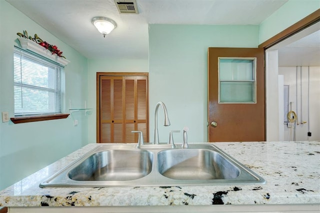 6205 S Choctaw Rd, Choctaw, OK 73020 - kitchen featuring visible vents, a sink, and light stone counters