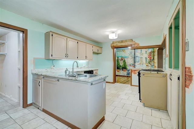 6205 S Choctaw Rd, Choctaw, OK 73020 - kitchen featuring a peninsula, light stone countertops, light tile patterned floors, and a sink