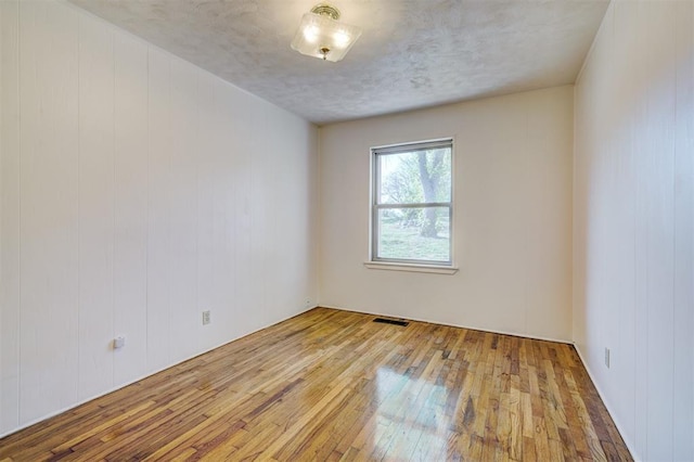 6205 S Choctaw Rd, Choctaw, OK 73020 - empty room featuring hardwood / wood-style floors and visible vents