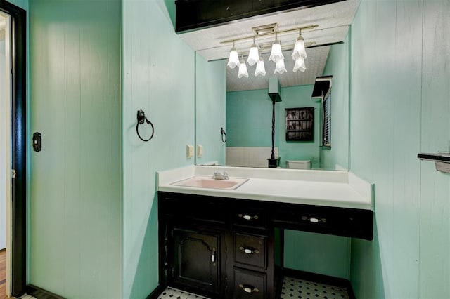 6205 S Choctaw Rd, Choctaw, OK 73020 - bathroom featuring track lighting, a textured ceiling, wood walls, and vanity