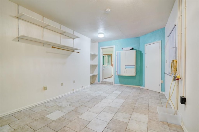 6205 S Choctaw Rd, Choctaw, OK 73020 - empty room featuring built in shelves, baseboards, and light tile patterned floors