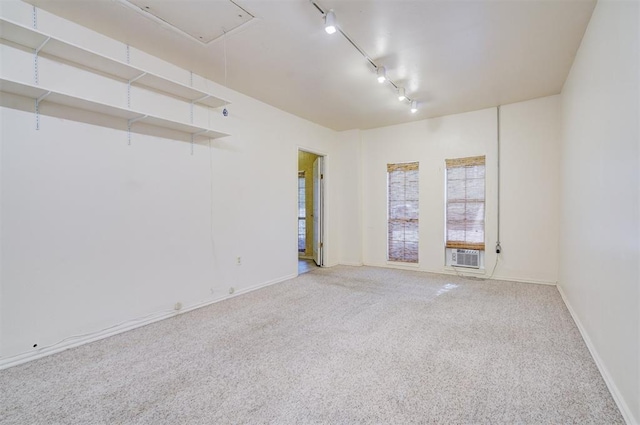 6205 S Choctaw Rd, Choctaw, OK 73020 - empty room featuring carpet, track lighting, baseboards, cooling unit, and attic access