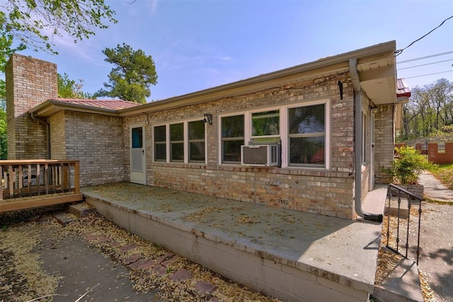 6205 S Choctaw Rd, Choctaw, OK 73020 - rear view of house featuring cooling unit, a chimney, metal roof, brick siding, and a deck