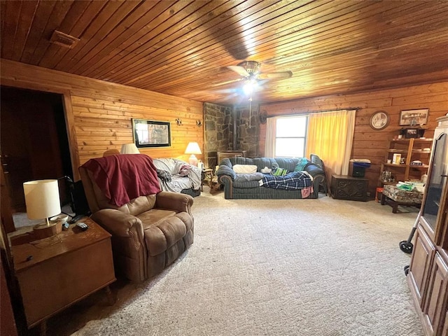 living room with wooden walls, carpet floors, wooden ceiling, and ceiling fan