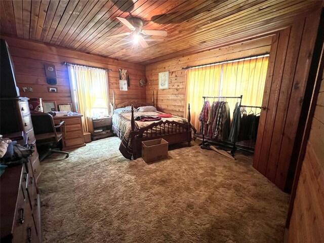 bedroom with wooden walls, carpet, wood ceiling, and ceiling fan