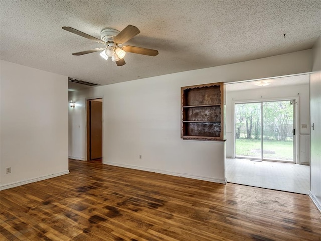 320 Willow Pl, Yukon, OK 73099 - spare room featuring a textured ceiling, visible vents, baseboards, a ceiling fan, and wood finished floors