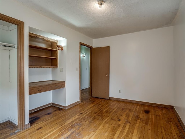 320 Willow Pl, Yukon, OK 73099 - unfurnished bedroom with baseboards and light wood-style flooring