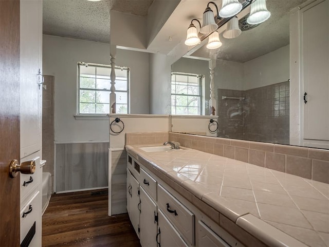 320 Willow Pl, Yukon, OK 73099 - bathroom with a wealth of natural light, wood finished floors, a shower, and a textured ceiling