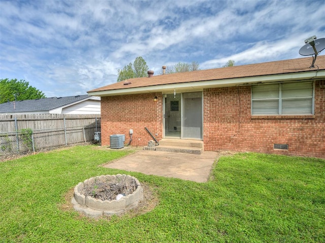 320 Willow Pl, Yukon, OK 73099 - back of house featuring brick siding, entry steps, a lawn, and fence