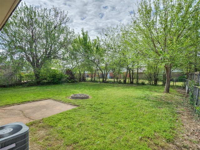 320 Willow Pl, Yukon, OK 73099 - view of yard featuring a patio, a fenced backyard, a fire pit, and central AC unit